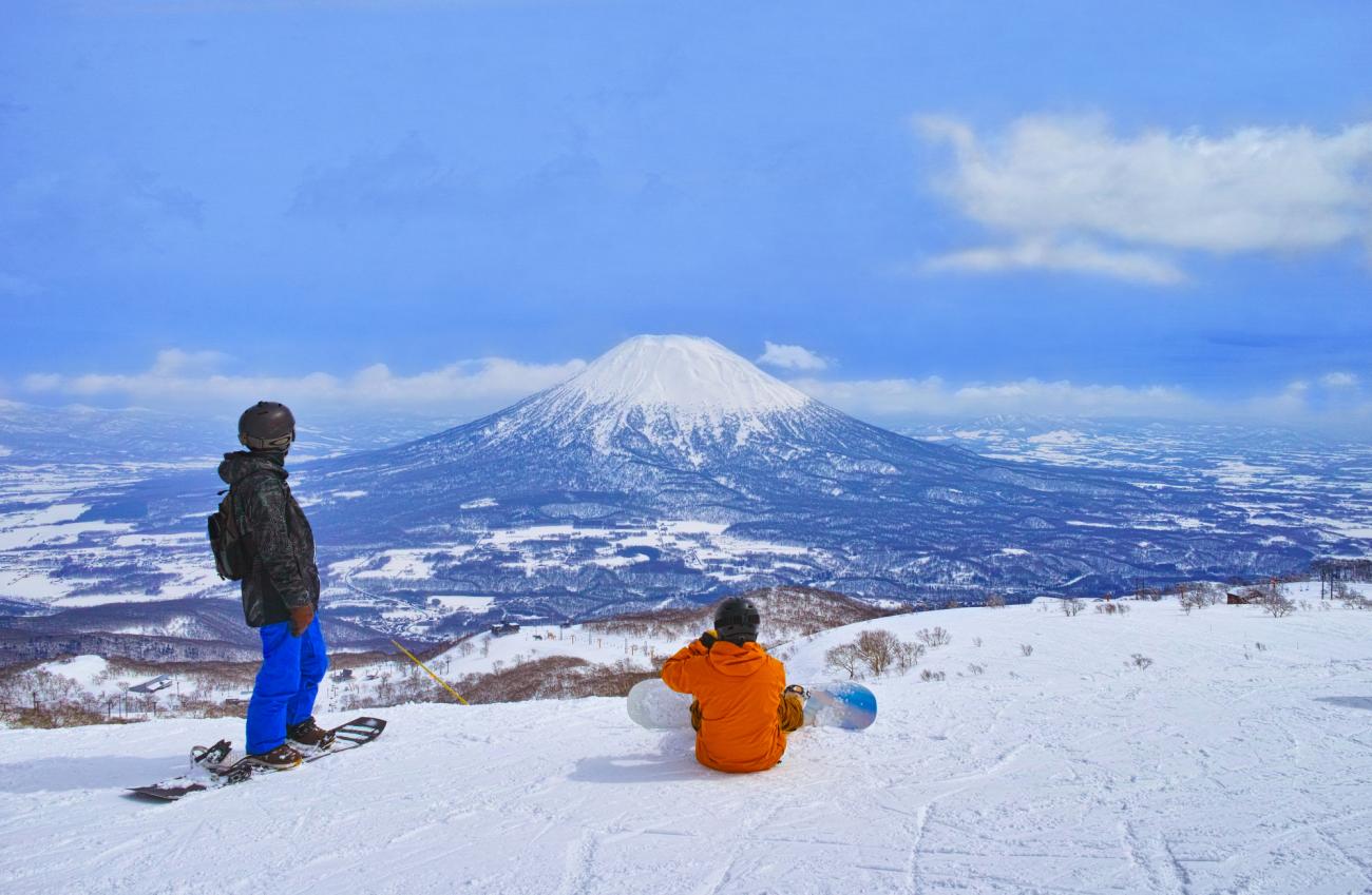 Family enjoying a luxury ski holiday in Niseko surrounded by snowy mountain