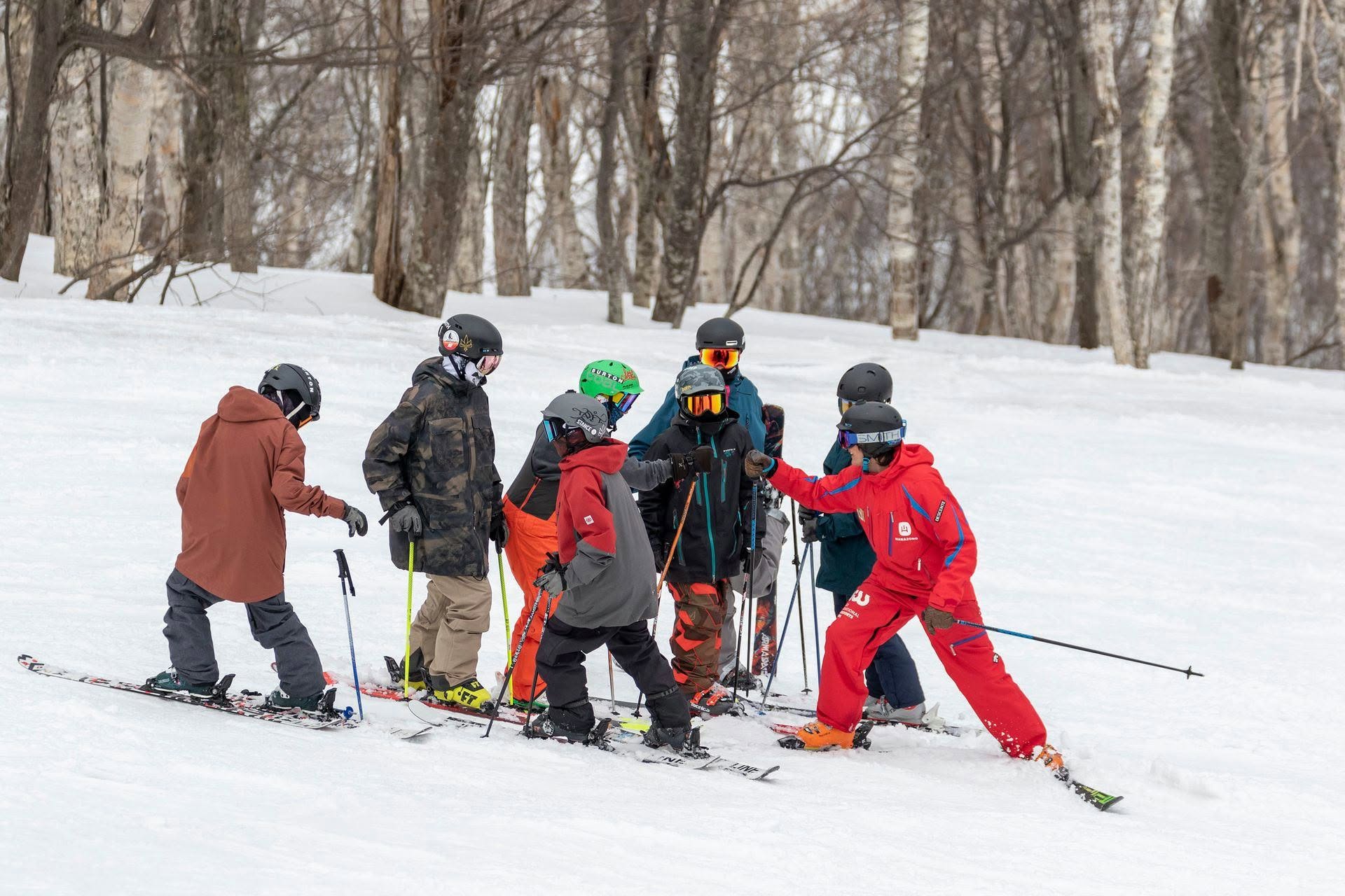 Family enjoying a ski holiday in Niseko, Hokkaido, Japan, with children skiing on snowy slopes and beautiful mountain scenery during winter 2026/27.